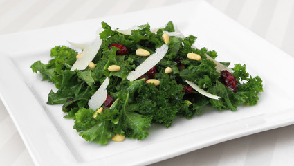 Kale salad served on a square plate.