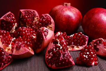 Ripe pomegranates on table close-up