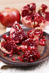 Ripe pomegranates on table close-up