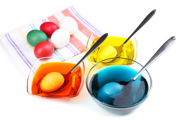 Bowls with paint for Easter eggs and eggs, isolated on white