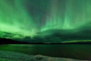 Fototapeta na wymiar Aurora borealis night sky over frozen Lake Laberge