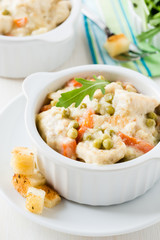 Chicken stew with carrrot and green peas in a creamy sauce