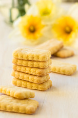 Cookies and spring flowers on white background