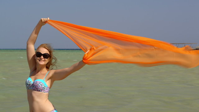 Woman with pareo waving in the wind