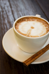 Coffee cup with cinnamon stick.