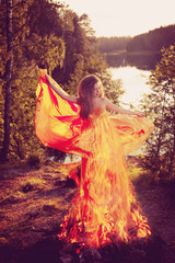 Beauty witch in the woods near the fire. Magic woman celebrating