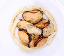 Mussels in a white plate.