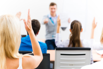Naklejka na ściany i meble female hand raised in class