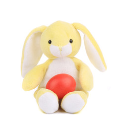 Yellow toy rabbit with easter egg.