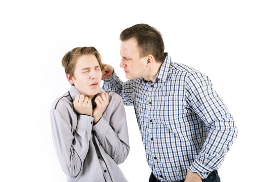 Strict father punishes his son.