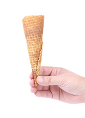 Hand holds empty ice cream corn