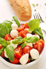 Caprese salad. Tomato and mozzarella with basil.