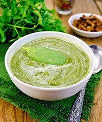Puree green with spinach and spoon on board
