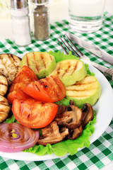 Delicious grilled vegetables on plate on table close-up