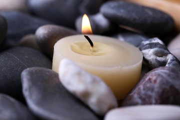 Fototapeta na wymiar Spa stones and candle, close-up