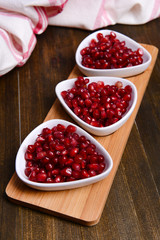 Ripe pomegranates on table close-up