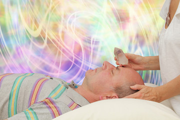 Crystal healer balancing third eye chakra