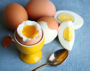 Boiled eggs on color wooden background