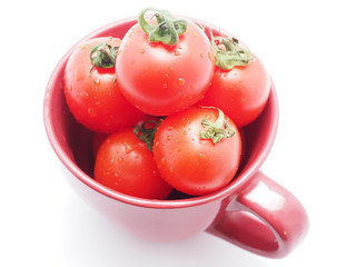 Tomatoes in a bowl on a white background