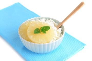 Bowl of tasty cottage cheese with pineapple, close up