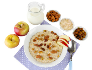 Tasty oatmeal with raisins and apples isolated on white