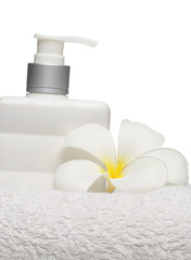 Fototapeta na wymiar square bottle soap and flower on white towel white background