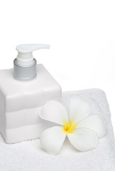 Obraz na płótnie Canvas square bottle soap and flower on white towel white background