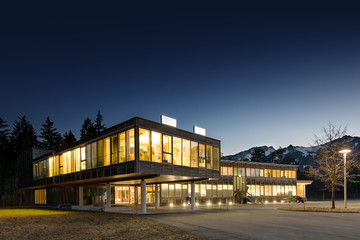 illuminated modern wooden office building at night