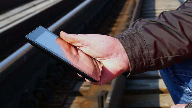 Railroad worker with tablet PC near railway