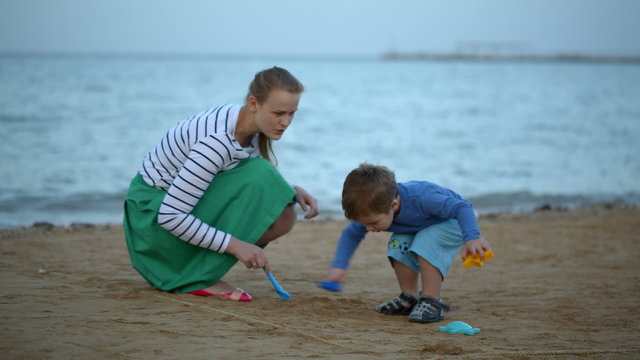 Mother and son playing on the beach