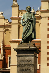 The statue of Adam Mickiewicz in front of the cloth hall in Krak - obrazy, fototapety, plakaty