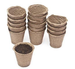 pile peat pots for growing seedlings, isolated on white backgrou