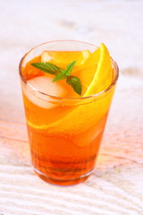 Orange cocktail on white wooden background
