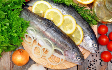 two rainbow trout with lemon and fresh vegetables