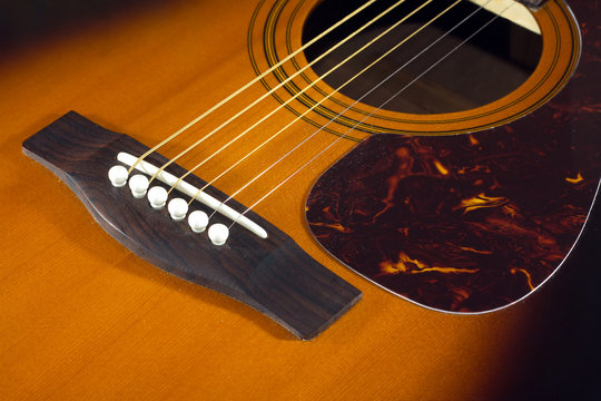Classic acoustic guitar top fragment with six strings closeup