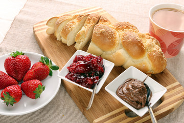 Sweet bread with cherry jam, and chocolate. Continental breakfas