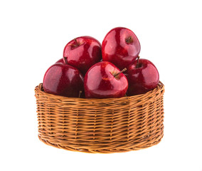 Fresh red apples in a wicker basket, isolated