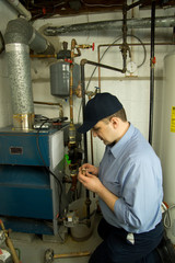 Plumber repairs gas furnace