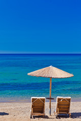 view of the beach with chairs and umbrellas