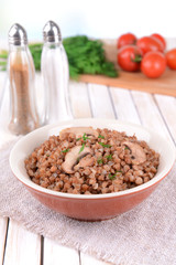Boiled buckwheat in bowl on table close-up