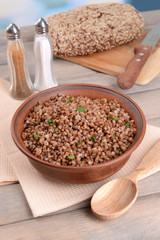 Boiled buckwheat in bowl on table close-up