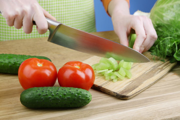 Female hands cutting celery