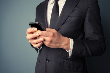 Young businessman using smart phone