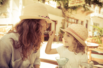 Hipster woman and girl in summer cafe