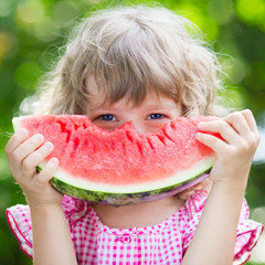 Happy child eating watermelon