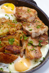 fried meat with potatoes and egg