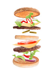 Delicious hamburger with flying ingredients