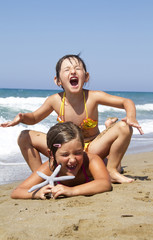 Fototapeta na wymiar happy girls on the beach