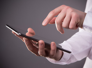 Hand touching digital tablet