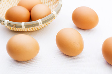 Fresh brown and white eggs on white cloth